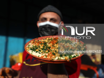 A Palestinian vender prepare chickpeas known as hummus for breakfasting during the Muslim fasting month of Ramadan in Gaza City on April 16,...