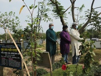 Relatives pray at the burial of their families at the Covid-19 special public cemetery in Dhaka, Bangladesh on April 16, 2021. (
