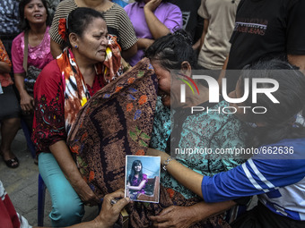 Family victim of air force-owned aircraft that crashed crying at hospital in Medan, North Sumatra, Indonesia on June 30, 2015. The Hercules...