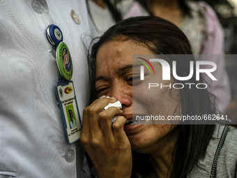 Family victim of air force-owned aircraft that crashed crying at hospital in Medan, North Sumatra, Indonesia on June 30, 2015. The Hercules...
