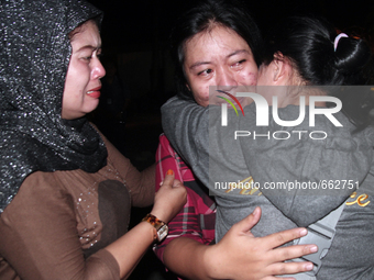 Indonesian women from one of the families of victims of the collapse of the Hercules C-130 cried hysterically when the bodies arrived at Ada...