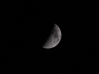 April half moon in the sky over Germany. In Aachen Schleckheim on April 19, 2021.(