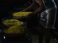A Workers produce glossy noodles also called Mie Glosor at a home industry in Bogor, Indonesia, on April 21, 2021. glossy noodles is food us...