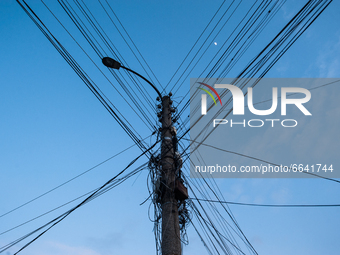 Street lamp in Yambol, Bulgaria, is overloaded with power wires and internet, cable tv and telephone cables, on April 20th 2021. Althought m...