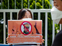 A South Koean activist holds a banner during a press conference outside of Indonesian Embassy in Korea on April 22, 2021 in Seoul, South Kor...
