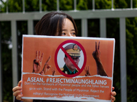 A South Koean activist holds a banner during a press conference outside of Indonesian Embassy in Korea on April 22, 2021 in Seoul, South Kor...