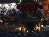 Nepalese Devotees offering rituals in front chariot during celebration of annual festival of Seto Machindranath Chariot festival at Kathmand...