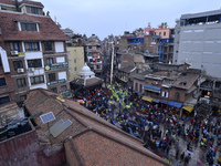 Nepalese Devotees pulling the chariot of Seto Machindranth along with the primary precaution wearing face mask and gloves during celebration...
