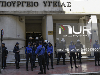 Police guard the entrance of the health Ministry as doctors and hospital staff demonstrate outside the Health Ministry, amid the coronavirus...