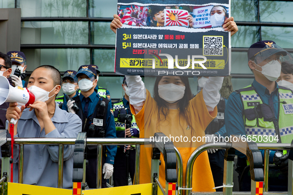 Some protesters shout slogans and hold a banner say the Japanese Government Should Drink Fukushima Radioactive Contaminated Water during a p...