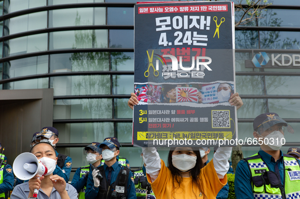 Some protesters shout slogans and hold a banner say the Japanese Government Should Drink Fukushima Radioactive Contaminated Water during a p...