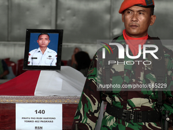 Relatives stood beside the coffin of the body bodies of military personnel, one of the victims of the collapse of the C-130 military aircraf...