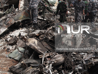 Indonesian military personnel to sort the rubble from the ruins of Indonesian aircraft C-130 Hercules day after the crash in Medan, North Su...