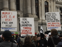 Demonstrators hold signs calling for the liberation of Mumia Abu-Jamal, Black People, and listing the names of some of those recently killed...