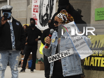 Close up of Pam Africa Speaking to the crowd wearing a sign the says innocent during a rally calling for the release of Mumia Abu-Jamal and...