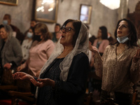 Christians take part in Palm Sunday Mass in the Church of Saint Porphyrius of the Holy Family, in Gaza City, Sunday, on April 25, 2021.
 (