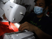 Workers Carry out the Production Process of one of the fashion products at the Torch workshop, in Bandung, West Java, on April, 25,2021. As...