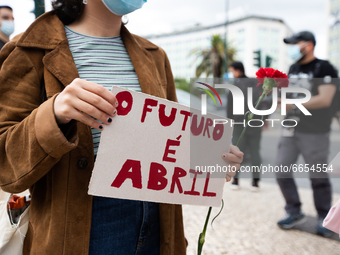 A women with a sign and the red carnation to commemorate the anniversary of the Portugal's revolution, in Lisbon, Portugal, on April 25, 202...