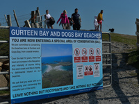 People seen at the entrance gate to Dog's Bay beach, seen during the COVID-19 lockdown. 
Next Monday there will be another slight easing of...