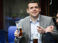 Scottish Conservative Leader Douglas Ross drinks a pint during a visit to a pub on April 26, 2021 in Edinburgh, Scotland. This visit come’s...