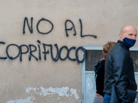 During the night, writings appeared against the 10 p.m. curfew of the Draghi government in Rieti, Italy, on April 26, 2021. (