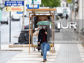 A man using umbrella to protect yourself from bad weather in Lisbon, Portugal, on April 26, 2021.
Lola Storm hits Portugal with winds and he...