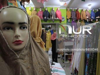 An Indonesian Muslim woman looking for headscarves at a hijab shop in Bogor on April 26, 2021, during the Muslim holy fasting month of Ramad...
