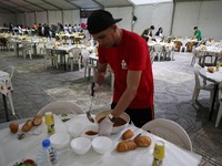 young volunteers work to break the fast of the needy during the month of Ramadan, in Algiers, Algeria on April 26, 2021, Muslims around the...