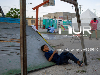 Migrant children play in the courtyard of the shelter of Ciudad Juarez Chihuahua, Mexico, on April 26, 2021. Hundreds of men and women accom...