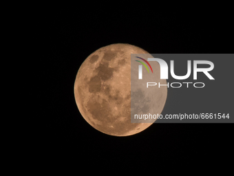 The full moon or Pink Super Moon is seen in the sky in Tanjungsari, Sumedang Regency, Indonesia on 27, April 2021. (