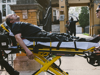 a fire fighter is carted off by EMS personnel after sustaining minor injuries of the Historic House In Palmer Square, Chicago, USA, on April...