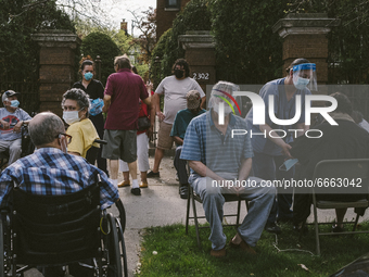 Elderly patients are escorted to the pavement as the centre is evacuated  from the Historic House In Palmer Square, Chicago, USA, on April 2...