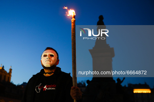 A protestor holds a torch while attending 'The List Of Shame' anti-government demonstration at the Main Square in Krakow, Poland on April 28...