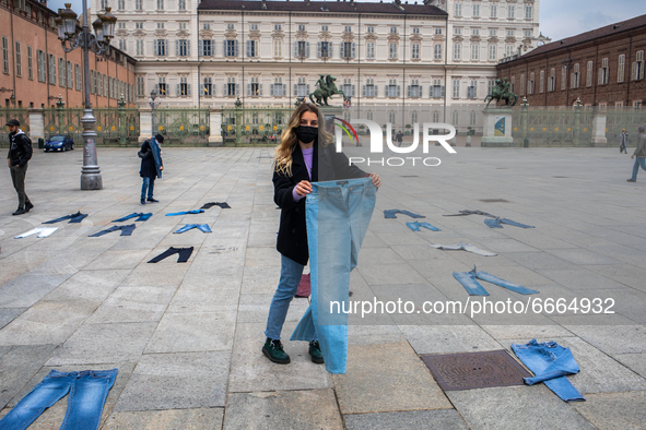  A woman holds a jeans during a flashmob to protest against gender violence in Piazza Castello, Turin, Italy, on April 28, 2021. The event t...