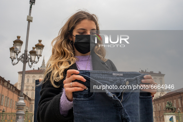  A woman holds a jeans during a flashmob to protest against gender violence in  Piazza Castello, Turin, Italy, on April 28, 2021. The event...