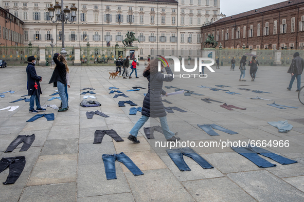 Women place jeans on the floor during a flashmob for the Denim Day promoted by  Break The Silence association to protest against gender viol...