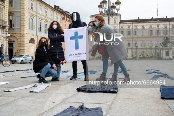 Andrea Villa Street artist poses for photo with A woman during a flashmob to protest against gender violence in Piazza Castello on April 28,...