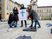 Andrea Villa Street artist poses for photo with A woman during a flashmob to protest against gender violence in Piazza Castello on April 28,...