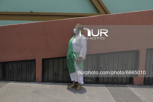 A woman dressed as St. Jude Thaddeus outside a parish of the same name located in Mexico City, Mexico, on April 28, 2021 where several peopl...