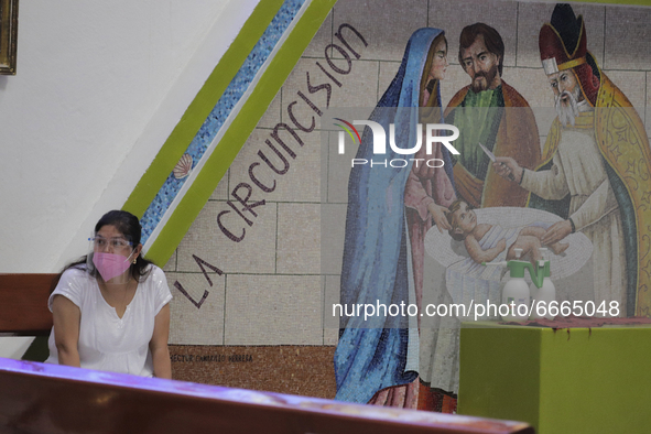 A volunteer from the Parish of St. Jude Thaddeus the Apostle located in Mexico City, Mexico, on April 28, 2021 in front of a mural of the Go...