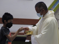 A priest offers communion and mass inside the Parish of St. Jude Thaddeus the Apostle located in Mexico City, Mexico, on April 28, 2021 duri...