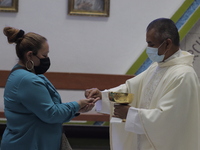 A priest offers communion and mass inside the Parish of St. Jude Thaddeus the Apostle located in Mexico City, Mexico, on April 28, 2021 duri...