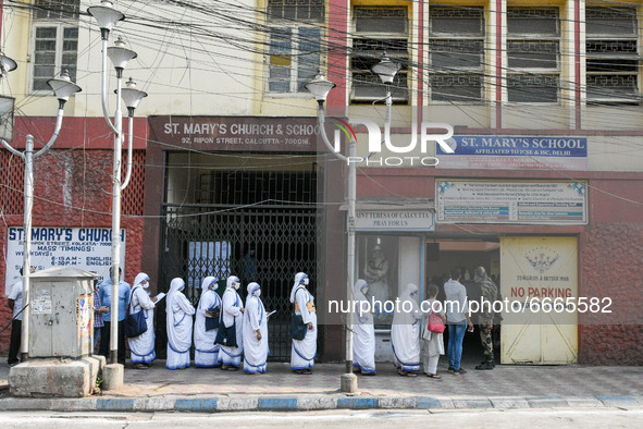 Sisters of Missionaries of Charity wait in queue in front of a polling station to cast their vote during the final phase of West Bengal asse...