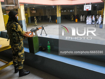 A CRPF personal stands guard at a polling station in Kolkata , India , on 29 April 2021 . (