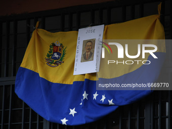 A Venezuelan flag with the image of the Venezuelan saint José Gregorio Hernandez is hung at the entrance of a home. San Cristobal, 30 April...