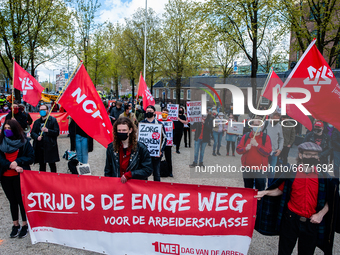 Groups of people are holding flags from several worker unions, during the International Worker's Day demonstration held in Amsterdam, on May...