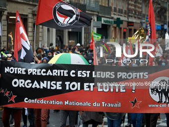 A banner from the CNT union reads 'Our precarity is their profits. Organize yourself and fight'. Thousands of people took to the streets for...