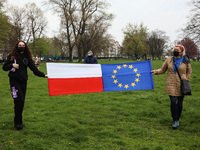 Women hold EU Polish and EU flags during celebration of 17-year of Polish membership in the European Union. Krakow, Poland on May 1st, 2021....