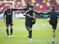  Brentford squad warms up during the Sky Bet Championship match between Brentford and Watford at the Brentford Community Stadium, Brentford...