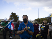 People take part in a demonstration to mark the International Workers Day, in San Juan, Puerto Rico, on May 1, 2021. (
